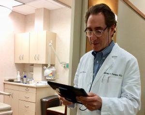Dr. Kaminer checking his iPad