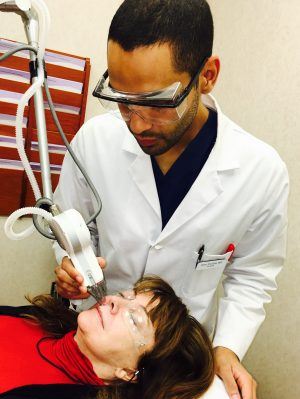 Dr. Omer Ibrahim treating lip lines with laser 
