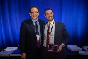 Fellow Dan Callaghan MD receiving his 2019 ASLMS award from Dr. Bernstein