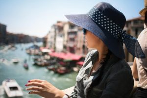 Women wearing a hat to protect her skin from the sun while sightseeing