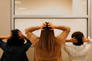 Three women scratching their heads