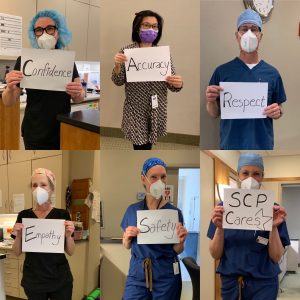 SkinCare Physicians' staff holding CARES values signs