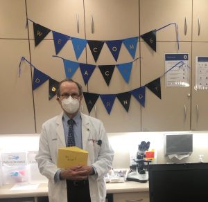 Dr. Arndt next to welcome-back decorations