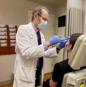 Dr. Arndt injecting Botox to patients forehead