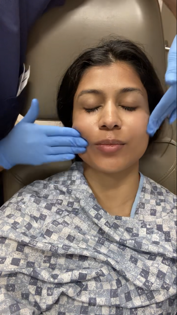 Applying SkinCeuticals C E Ferulic (Vitamin C serum) on Dr. Christman's face after Fraxel treatment