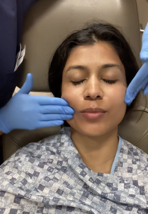 Applying SkinCeuticals C E Ferulic (Vitamin C serum) on Dr. Christman's face after Fraxel treatment
