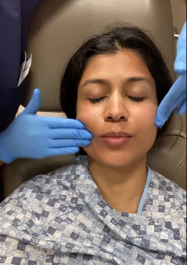 Applying SkinCeuticals C E Ferulic (Vitamin C serum) on Dr. Christman's face after Fraxel treatment