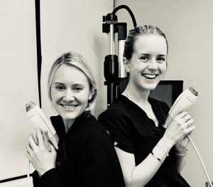 Dr. Halgstrom and Dr. Jessica Labadie back-to-back, each holding a Clear + Brilliant device
