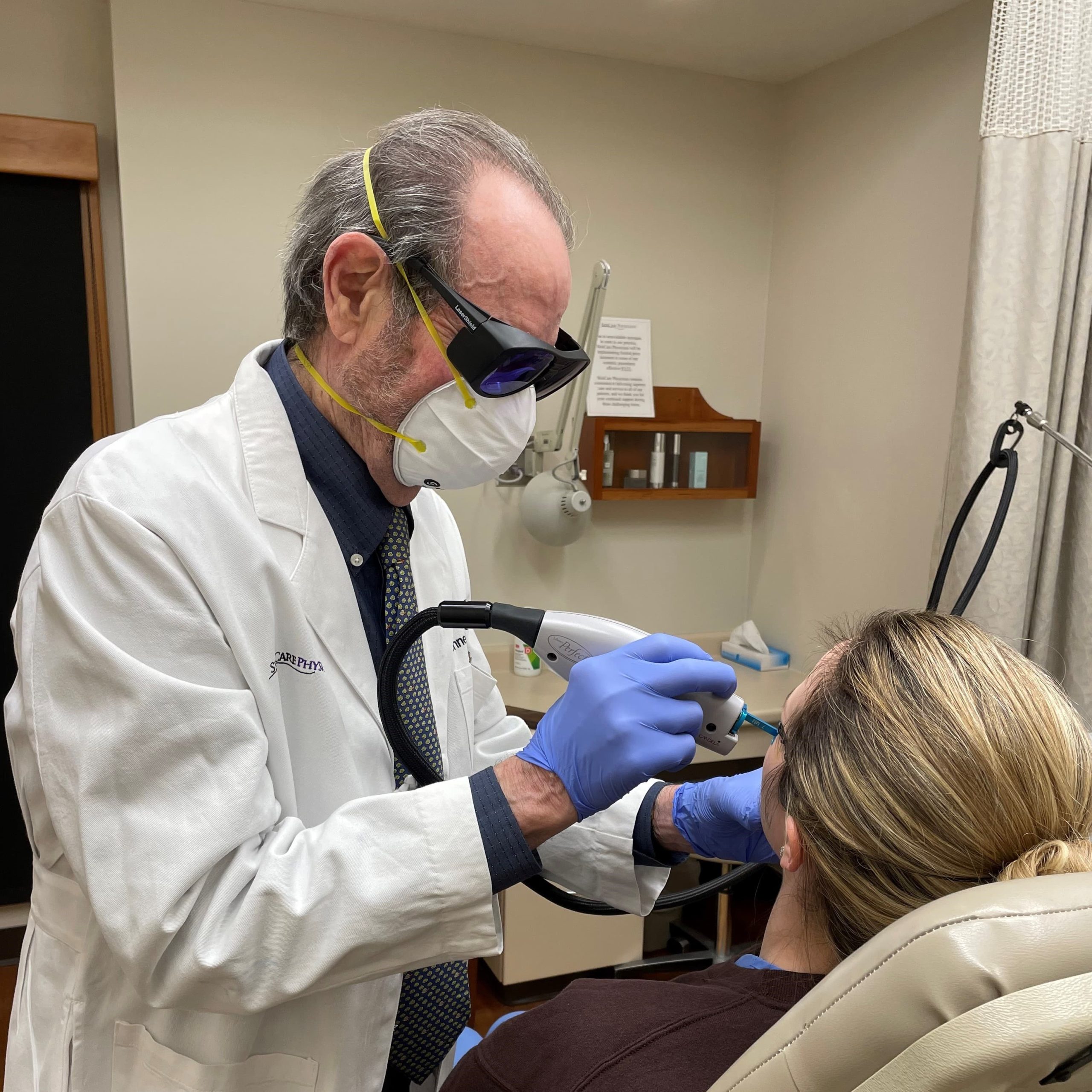 Dr. Arndt treating red cheeks with a laser