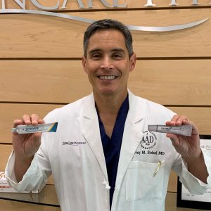 Dr. Jeffrey Sobell with samples of Zoryve and Vtama, non-steroidal creams for psoriasis.