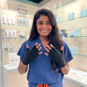 Dr. Kandula wearing UV gloves for a gel manicure