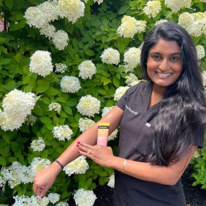 Dr. Prasanthi Kandula applying sunscreen on her arm