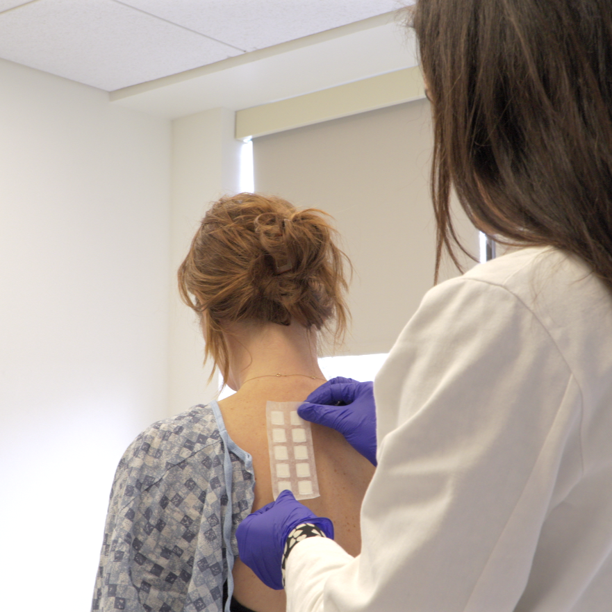 Dr. Stout applying a patch test to identify the cause of her patient's skin allergy