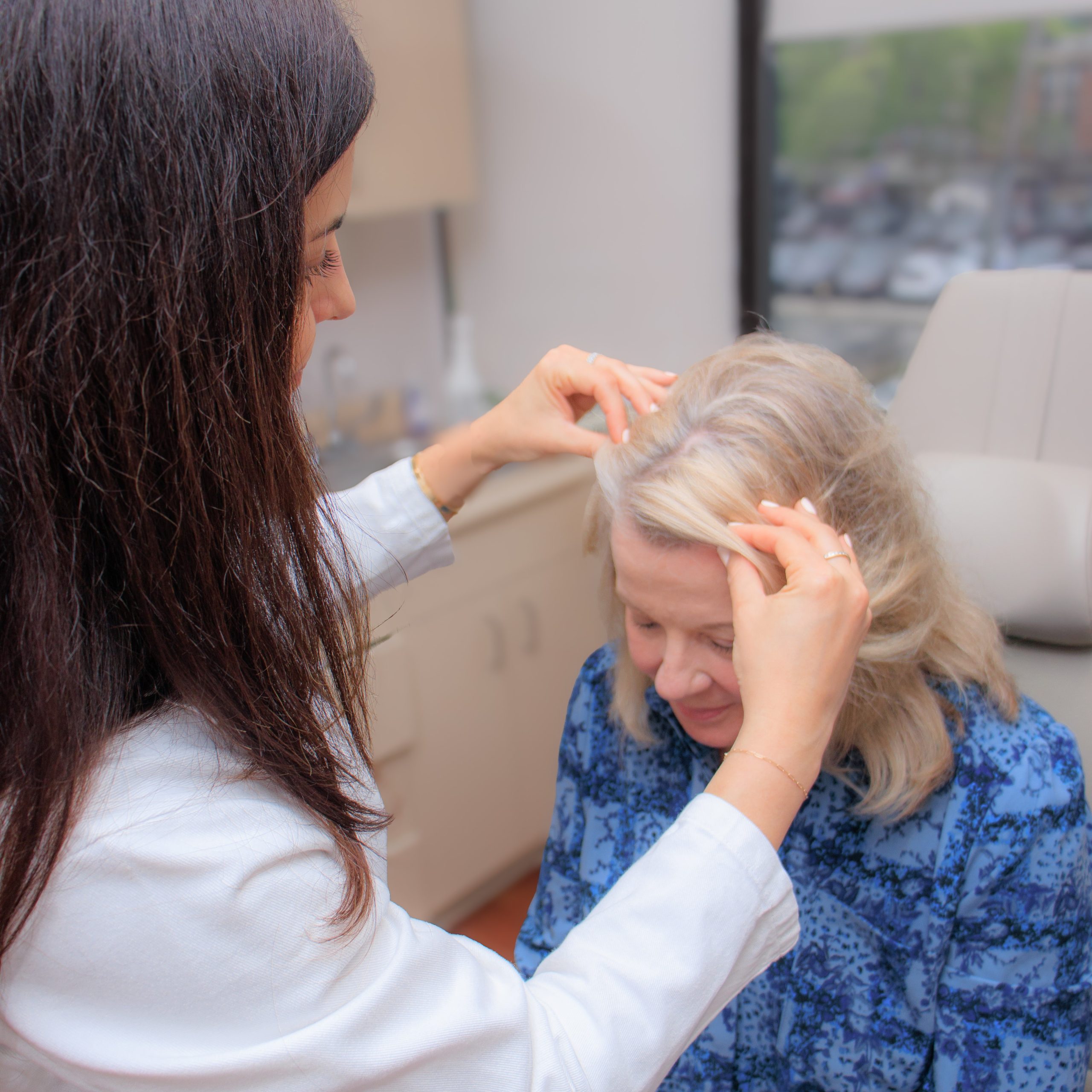 Dermatologist diagnosing hair loss on a women